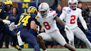 Ohio State Buckeyes linebacker Arvell Reese (8) tackles Michigan Wolverines running back Bryson Kuzdzal (24) during the NCAA football game at Michigan Stadium in Ann Arbor, Mich. on Nov. 29, 2025. Ohio State won 27-9.