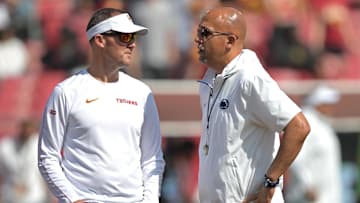 USC Trojans head coach Lincoln Riley, left, talks with Penn State Nittany Lions head coach James Franklin