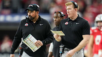 Ohio State Buckeyes tight ends coach Keenan Bailey, right, and head coach Ryan Day walk along the sideline during the Big Ten Conference championship game at Lucas Oil Stadium in Indianapolis on Dec. 6, 2025. Ohio State lost 13-10.
