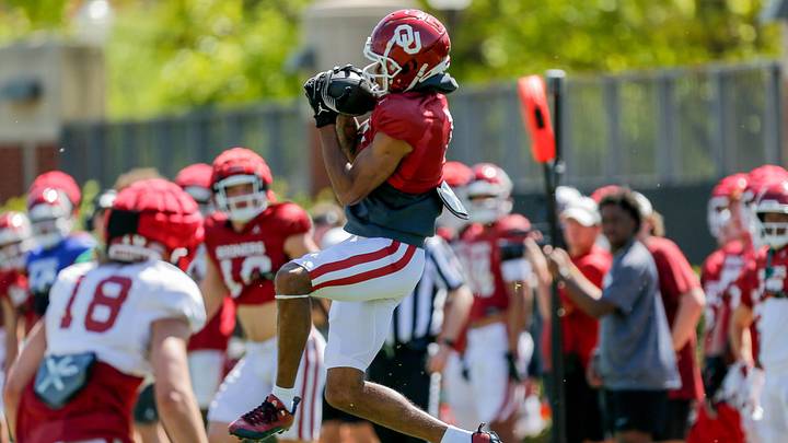 Jayden Gibson (1) caches a pass during an Oklahoma football practice in Norman, Okla., on Friday, April 12, 2024.