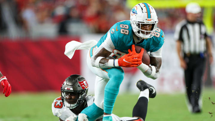 Aug 23, 2024; Tampa, Florida, USA; Miami Dolphins tight end Jody Fortson Jr. (88) is brought down by Tampa Bay Buccaneers linebacker Chris Braswell (43) in the third quarter during preseason at Raymond James Stadium.