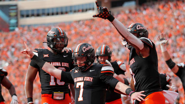 Oklahoma State Cowboys quarterback Alan Bowman celebrates a touchdown in a college football game in the Big 12.