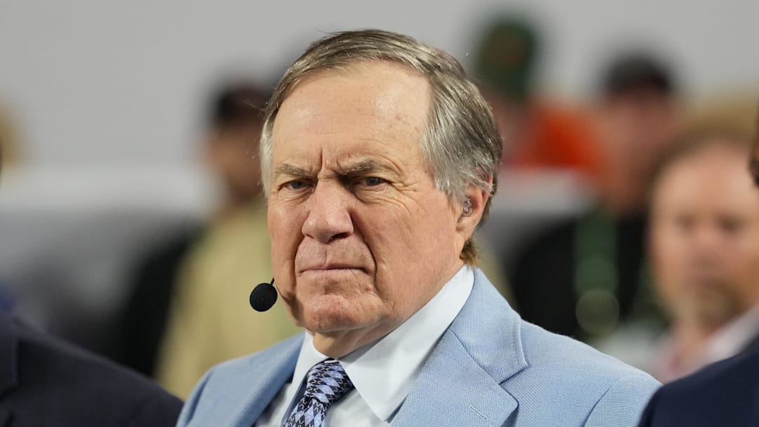 Jan 19, 2026; Miami Gardens, FL, USA; TV analyst Bill Belichick watches the Miami Hurricanes play the Indiana Hoosiers during the first half of the College Football Playoff National Championship game at Hard Rock Stadium. Mandatory Credit: Kirby Lee-Imagn Images