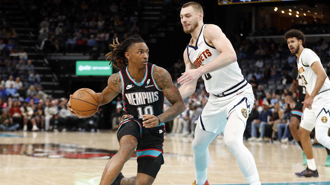 Mar 18, 2026; Memphis, Tennessee, USA; Memphis Grizzlies guard Javon Small (10) dribbles as Denver Nuggets guard Christian Braun (0) defends during the second quarter at FedExForum. Mandatory Credit: Petre Thomas-Imagn Images