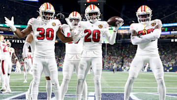 San Francisco 49ers defensive backs George Odum (30) and Ambry Thomas (20)