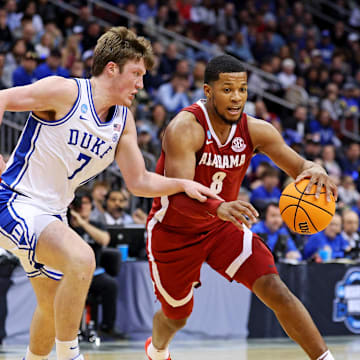 Mar 29, 2025; Newark, NJ, USA; Alabama Crimson Tide guard Chris Youngblood (8) drives to the basket against Duke Blue Devils guard Kon Knueppel (7) during the second half in the East Regional final of the 2025 NCAA tournament at Prudential Center. Mandatory Credit: Vincent Carchietta-Imagn Images