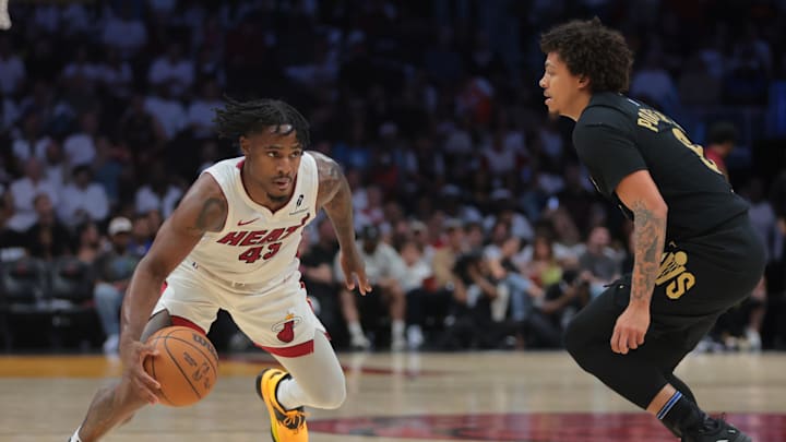 Apr 28, 2025; Miami, Florida, USA; Miami Heat guard Davion Mitchell (45) drives to the basket against Cleveland Cavaliers guard Craig Porter Jr. (9) in the fourth quarter during game four for the first round of the 2025 NBA Playoffs at Kaseya Center. Mandatory Credit: Sam Navarro-Imagn Images