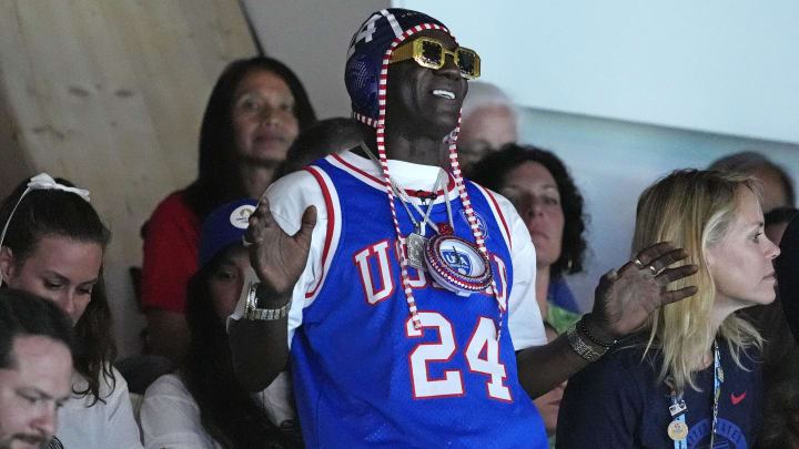 Jul 27, 2024; Paris, France; Recording artist Flavor Flav cheers during the match between Greece and United States of America in women’s water polo group B play during the Paris 2024 Olympic Summer Games at Aquatics Centre. Mandatory Credit: Michael Madrid-USA TODAY Sports