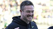 Nov 22, 2025; Eugene, Oregon, USA; Oregon Ducks head coach Dan Lanning smiles before the game against the Southern California Trojans at Autzen Stadium. Mandatory Credit: Troy Wayrynen-Imagn Images