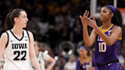 Angel Reese (10) shows Iowa Caitlin Clark her ring finger during the final seconds of the women's 2023 NCAA Tournament national championship game.