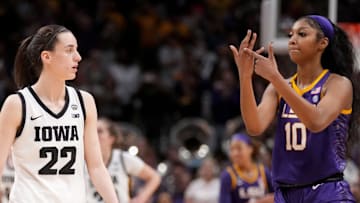 Angel Reese (10) shows Iowa Caitlin Clark her ring finger during the final seconds of the women's 2023 NCAA Tournament national championship game.