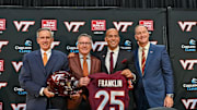 Nov 19, 2025; Blacksburg, VA, USA;  L-R, John Rocovich, Timothy Sands, James Franklin and Whit Babcock hold up a Virginia Tech jersey during the press conference celebrating Franklin as head coach at Cassell Coliseum. Mandatory Credit: Brian Bishop-Imagn Images