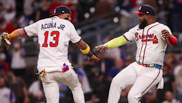 Atlanta Braves right fielder Ronald Acuna Jr. (13) and designated hitter Marcell Ozuna (20) celebrate after a victory over the Chicago Cubs at Truist Park.