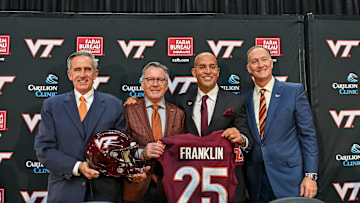 Nov 19, 2025; Blacksburg, VA, USA;  L-R, John Rocovich, Timothy Sands, James Franklin and Whit Babcock hold up a Virginia Tech jersey during the press conference celebrating Franklin as head coach at Cassell Coliseum. Mandatory Credit: Brian Bishop-Imagn Images