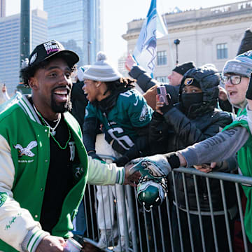 Feb 14, 2025; Philadelphia, PA, USA; Philadelphia Eagles defensive tackle Thomas Booker IV (59) celebrates with fans during the Super Bowl LIX championship parade and rally. Mandatory Credit: Caean Couto-Imagn Images