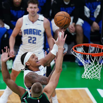 Orlando Magic forward Paolo Banchero (5) drives to the basket against Boston Celtics center Kristaps Porzingis (8) in the first quarter during game five of first round for the 2025 NBA Playoffs at TD Garden. 
