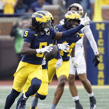 Oct 18, 2025; Ann Arbor, Michigan, USA;  Michigan Wolverines defensive back Jacob Oden (5) celebrates after he makes an interception in the second half against the Washington Huskies at Michigan Stadium. Mandatory Credit: Rick Osentoski-Imagn Images