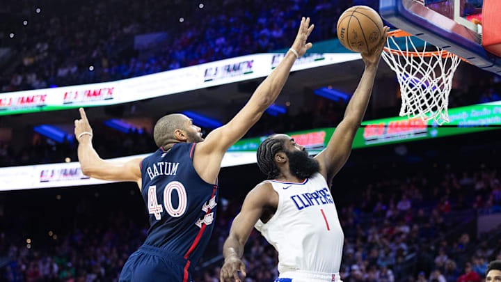 Mar 27, 2024; Philadelphia, Pennsylvania, USA; LA Clippers guard James Harden (1) drives for a shot past Philadelphia 76ers forward Nicolas Batum (40) during the fourth quarter at Wells Fargo Center. Mandatory Credit: Bill Streicher-Imagn Images