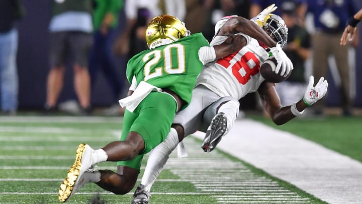 Sep 23, 2023; South Bend, Indiana, USA; Ohio State Buckeyes wide receiver Marvin Harrison Jr. (18) makes a catch as Notre Dame Fighting Irish cornerback Benjamin Morrison (20) defends in the second quarter at Notre Dame Stadium. The catch was reviewed and ruled and incomplete pass and Morrison was given a pass interference penalty. Mandatory Credit: Matt Cashore-USA TODAY Sports