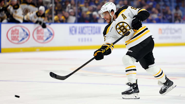 Apr 6, 2025; Buffalo, New York, USA;  Boston Bruins right wing David Pastrnak (88) takes a shot on goal during the third period against the Buffalo Sabres at KeyBank Center. Mandatory Credit: Timothy T. Ludwig-Imagn Images