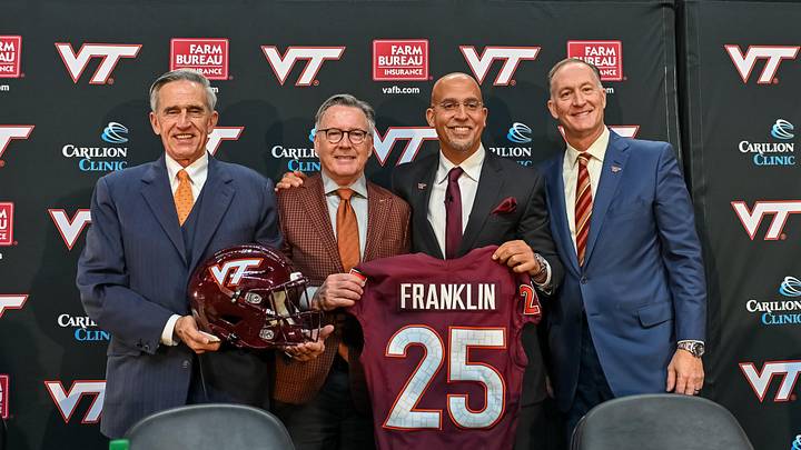 Nov 19, 2025; Blacksburg, VA, USA;  L-R, John Rocovich, Timothy Sands, James Franklin and Whit Babcock hold up a Virginia Tech jersey during the press conference celebrating Franklin as head coach at Cassell Coliseum. Mandatory Credit: Brian Bishop-Imagn Images