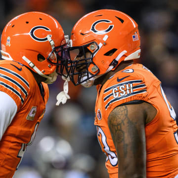 Nov 9, 2023; Chicago, Illinois, USA; Chicago Bears defensive back Eddie Jackson (4) and defensive tackle Justin Jones (93) celebrate a sack against the Carolina Panthers during the second quarter at Soldier Field. Mandatory Credit: Daniel Bartel-USA TODAY Sports