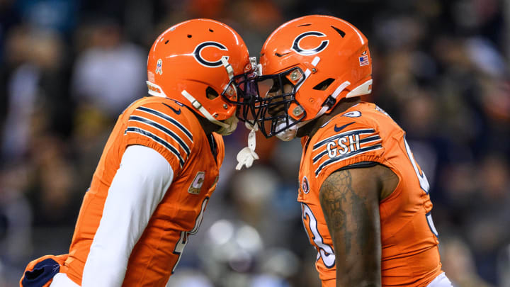 Nov 9, 2023; Chicago, Illinois, USA; Chicago Bears defensive back Eddie Jackson (4) and defensive tackle Justin Jones (93) celebrate a sack against the Carolina Panthers during the second quarter at Soldier Field. Mandatory Credit: Daniel Bartel-USA TODAY Sports