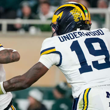 Oct 25, 2025; East Lansing, Michigan, USA; Michigan Wolverines running back Jordan Marshall (23) takes the handoff from quarterback Bryce Underwood (19) against the Michigan State Spartans at Spartan Stadium. Mandatory Credit: Brendan Mullin-Imagn Images
