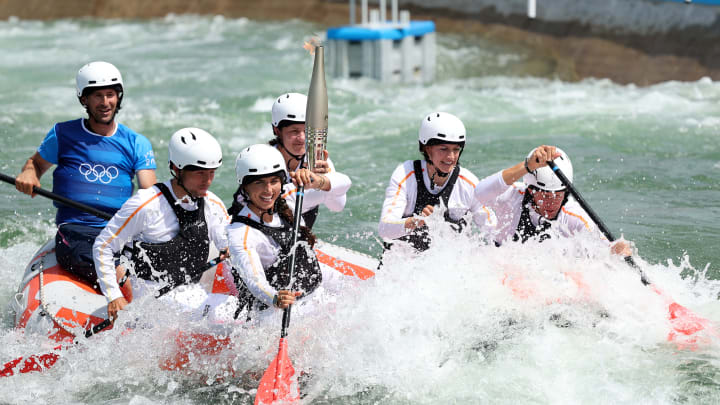 Whitewater rafters carry the Olympic torch on its way to Paris.