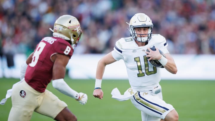 Aug 24, 2024; Dublin, IRL; Georgia Tech quarterback Haynes King runs with the ball against Florida State defensive back Azareyeíh Thomas at Aviva Stadium. Mandatory Credit: Tom Maher/INPHO via USA TODAY Sports