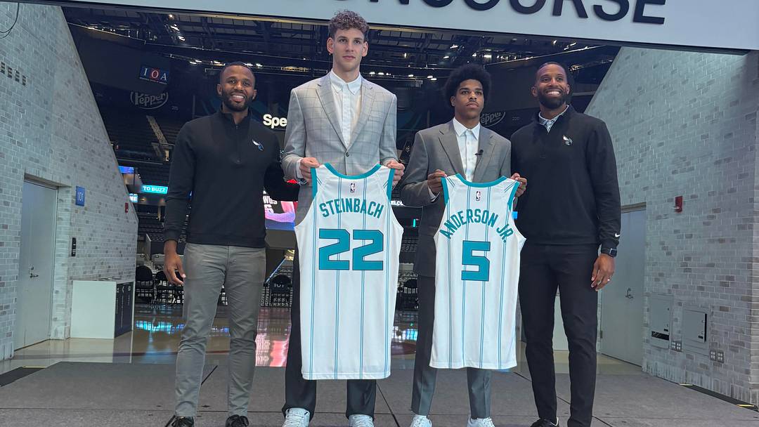 Jeff Peterson, Hannes Steinbach, Christian Anderson Jr., and Charles Lee pose for a post-press conference photo-op.