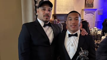 Gonzaga's Kainoa Winston and his father Kelvin share a proud moment as Kainoa grasps his DC Touchdown Club Washington, D.C. Player of the Year Award.