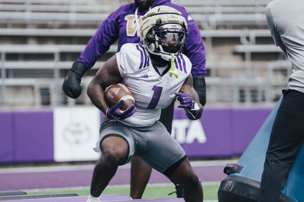 Jonah Coleman takes a stutter step during a UW practice. 