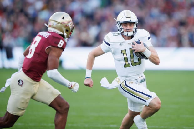 Haynes King tries to elude Florida State defender.