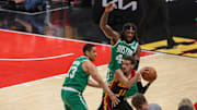 Apr 27, 2023; Atlanta, Georgia, USA; Atlanta Hawks guard Trae Young (11) is defended by Boston Celtics guard Malcolm Brogdon (13) and center Robert Williams III (44) in the second half during game six of the 2023 NBA playoffs at State Farm Arena. Mandatory Credit: Brett Davis-Imagn Images