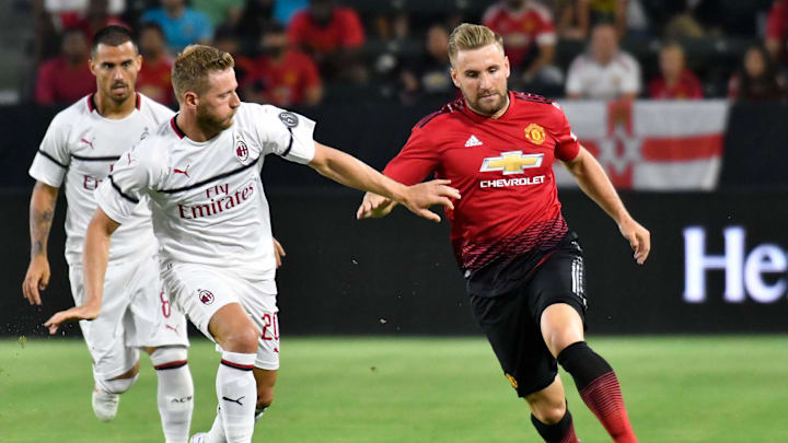Jul 25, 2018; Carson , CA, USA; Manchester United defender Luke Shaw (23) moves the ball past Milan defender Ignazio Abate (20) in the first half during an International Champions Cup soccer match at Stubhub Center. Mandatory Credit: Robert Hanashiro-Imagn Images