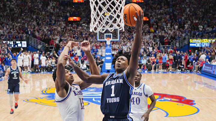 Jan 31, 2026; Lawrence, Kansas, USA; BYU Cougars guard Robert Wright III (1) shoots against Kansas Jayhawks forward Bryson Tiller (15) during the second half at Allen Fieldhouse. Mandatory Credit: Jay Biggerstaff-Imagn Images