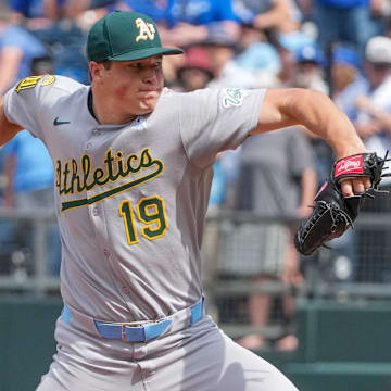 Jun 15, 2025; Kansas City, Missouri, USA; Athletics pitcher Mason Miller (19) delivers a pitch against the Kansas City Royals in the ninth inning of the game at Kauffman Stadium. Mandatory Credit: Denny Medley-Imagn Images