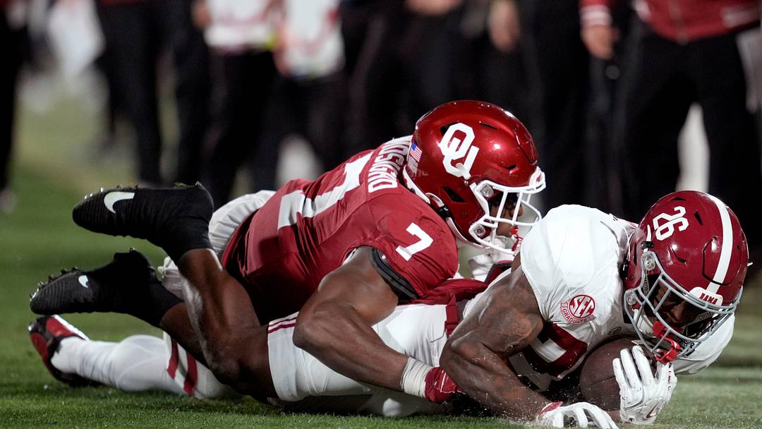 Oklahoma Sooners linebacker Sammy Omosigho (7) brings down Alabama Crimson Tide running back Jamarion Miller (26) during a first-round College Football Playoff game between the University of Oklahoma Sooners (OU) and the Alabama Crimson Tide at Gaylord Family - Oklahoma Memorial Stadium in Norman, Okla., Friday, Dec. 19, 2025. Alabama won 34-24.