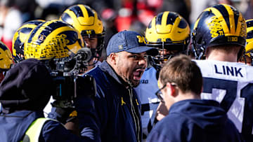 Michigan offensive line coach Grant Newsome talks to players in a huddle during warm up before the game between Ohio State and Michigan at Ohio Stadium in Columbus, Ohio on Saturday, Nov. 30, 2024.