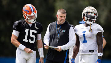 Florida Gators head coach Billy Napier talks with Florida Gators quarterback Graham Mertz (15) and Florida Gators running back Montrell Johnson Jr. (1) during fall football practice at Heavener Football Complex at the University of Florida in Gainesville, FL on Thursday, August 1, 2024. [Matt Pendleton/Gainesville Sun]