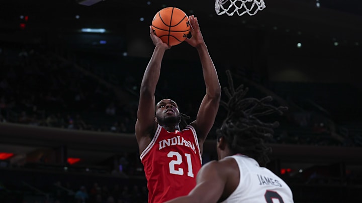 Indiana forward Mackenzie Mgbako (21) shoots over Louisville guard Mike James at Madison Square Garden in New York in November 2023.