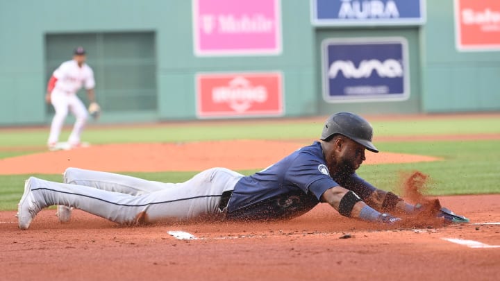 Seattle Mariners center fielder Victor Robles (10) slides into home plate against the Boston Red Sox during the first inning at Fenway Park on July 30.