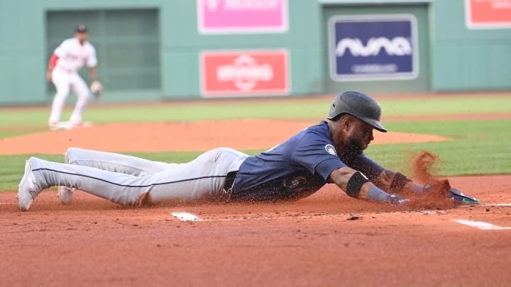 Seattle Mariners center fielder Victor Robles (10) slides into home plate against the Boston Red Sox during the first inning at Fenway Park on July 30.