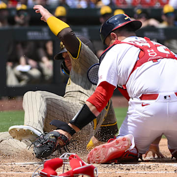 San Diego Padres left fielder Gavin Sheets (30) slides safely past St. Louis Cardinals catcher Pedro Pages (43) during the fourth inning at Busch Stadium on July 27.