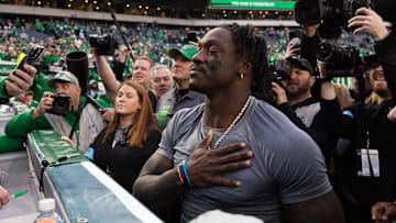 Dec 29, 2024; Philadelphia, Pennsylvania, USA; Philadelphia Eagles wide receiver A.J. Brown thanks a fan for returning the first NFL touchdown pass of quarterback Tanner McKee (not pictured) after a victory against the Dallas Cowboys at Lincoln Financial Field. Mandatory Credit: Bill Streicher-Imagn Images