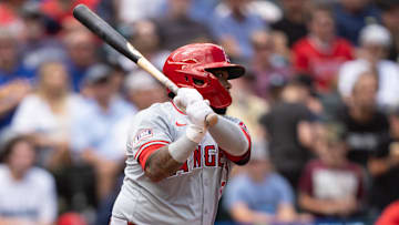Jul 24, 2024; Seattle, Washington, USA;  Los Angeles Angels designated hitter Willie Calhoun (5) hits an RBI-single during the eighth inning at T-Mobile Park. Mandatory Credit: Stephen Brashear-Imagn Images