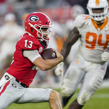 Oct 10, 2020; Athens, Georgia, USA; Georgia Bulldogs quarterback Stetson Bennett (13) runs with the ball against the Tennessee Volunteers during the second half at Sanford Stadium. Mandatory Credit: Dale Zanine-Imagn Images