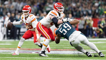 Feb 9, 2025; New Orleans, LA, USA;  Kansas City Chiefs quarterback Patrick Mahomes (15) scrambles as guard Joe Thuney (62) blocks Philadelphia Eagles defensive tackle Thomas Booker IV (59) in Super Bowl LIX at Ceasars Superdome. Mandatory Credit: Mark J. Rebilas-Imagn Images