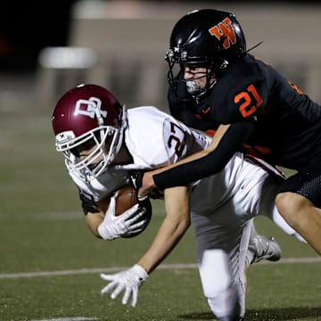 West De Pere's Cooper Borowicz (21) makes a tackle versus De Pere during a Fox River Classic Conference (North Division) game on Sept. 27, 2024